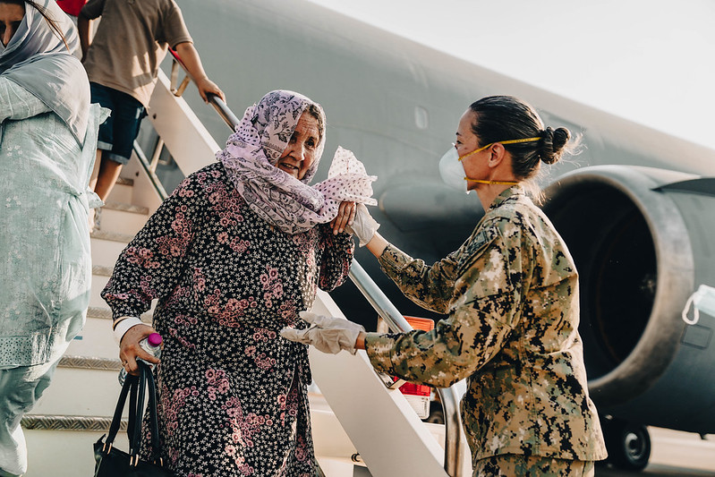 Master Chief Anna Wood assists an Afghanistan evacuee during the U.S. withdrawal from Afghanistan.