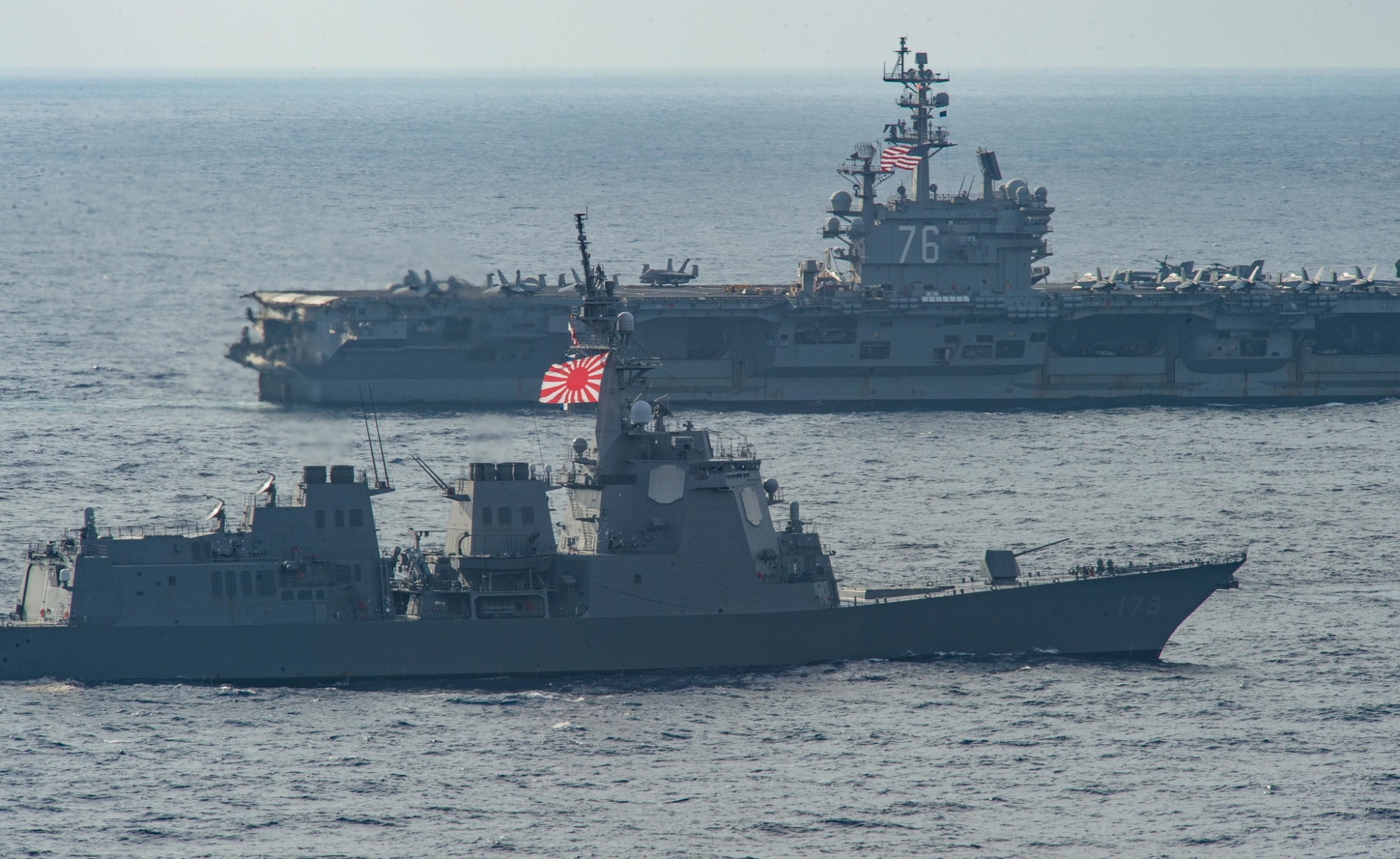A Japan Maritime Self-Defense Force ship conducts operations alongside the USS Ronald Reagan (CVN-76) during Keen Sword 23. (U.S. Navy 7 Fleet; CC 1.0)